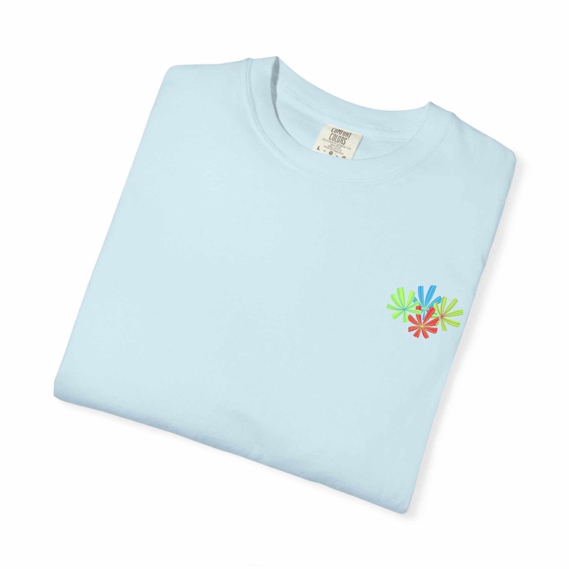 Island Tropical T-shirt with floral design on light blue fabric, showing unisex style.
